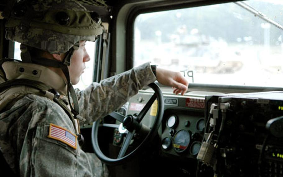 A 1st Armored Division soldier drives a Humvee during a training exercise at Hohenfels Training Area, Germany. The division is preparing for a return deployment to Iraq. The exercise included German actors playing Iraqi villagers to help soldiers interact with locals while in Iraq.