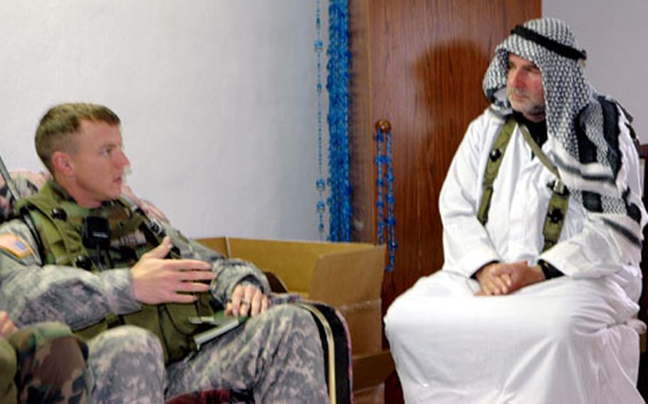 Let&#39;s make a deal: Capt. Chris Kuzio talks business with the fake sheik of the fake village of Rusafa, during a 1st Armored Division training exercise at Hohenfels.