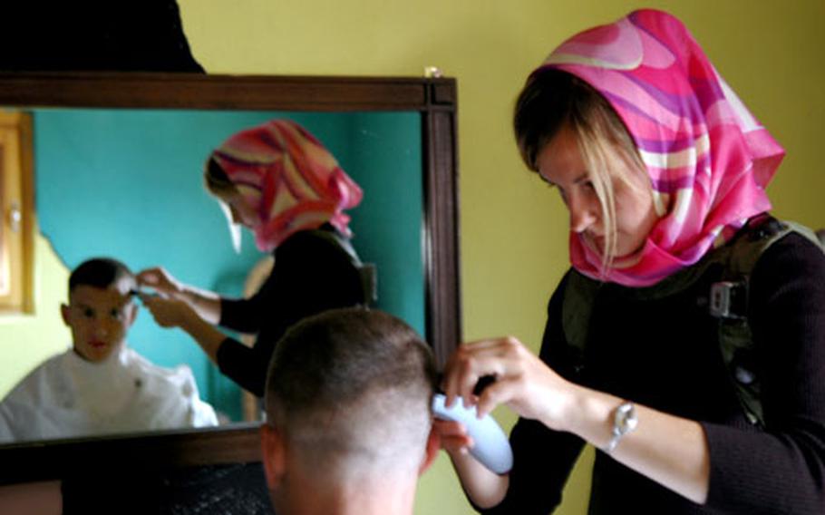 Mingling with the Iraqi population will be a crucial part of mission success in their upcoming deployment, said Capt. Chris Kuzio, who stopped for a haircut at the fake village of Rusada during a training exercise last week at Hohenfels.