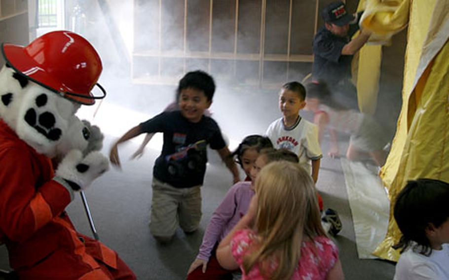 First-graders learn how to evacuate from a smoke-filled room during a simulation in a fire-safety awareness class Friday at Naval Air Facility Atsugi’s Shirley Lanham Elementary School.