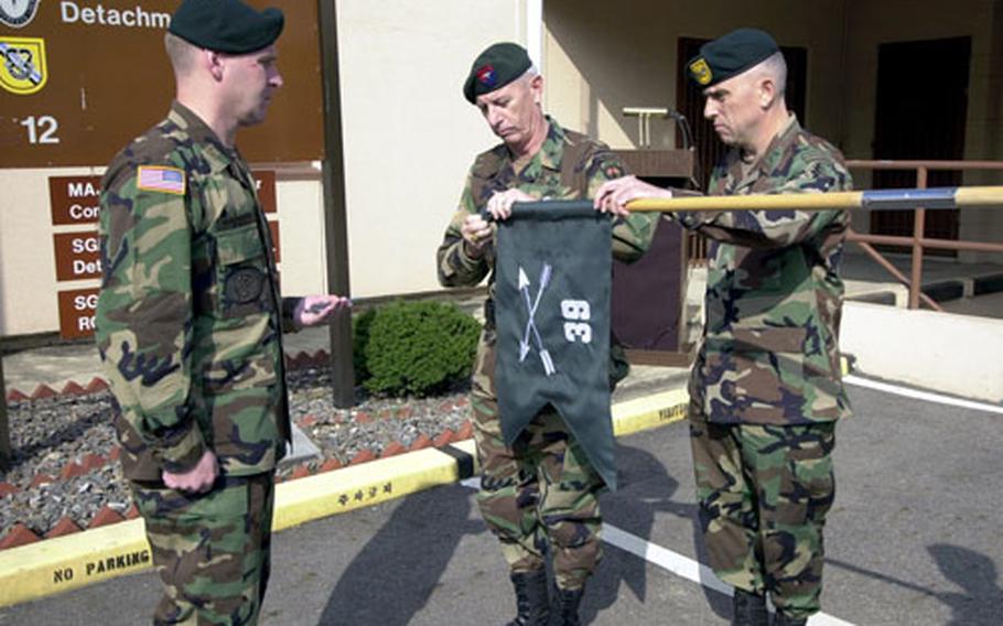 From left, Maj. Robert Burmaster, Brig. Gen. Richard W. Mills and Col. Richard Thomas take part in a redesignation ceremony Friday at the Republic of Korea Warfare Command Headquarters south of Seoul.