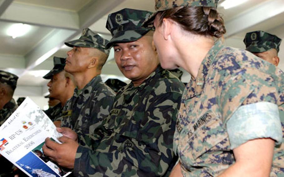 Capt. Jennifer A. Mercer, right, the supply officer with the 31st Marine Expeditionary Unit, talks with a Philippine marine.