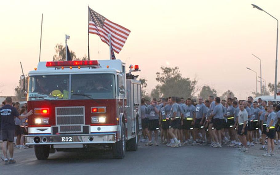 Runners line up behind a Forward Operating Base Speicher fire engine before the start of the Big Easy 5K Run.