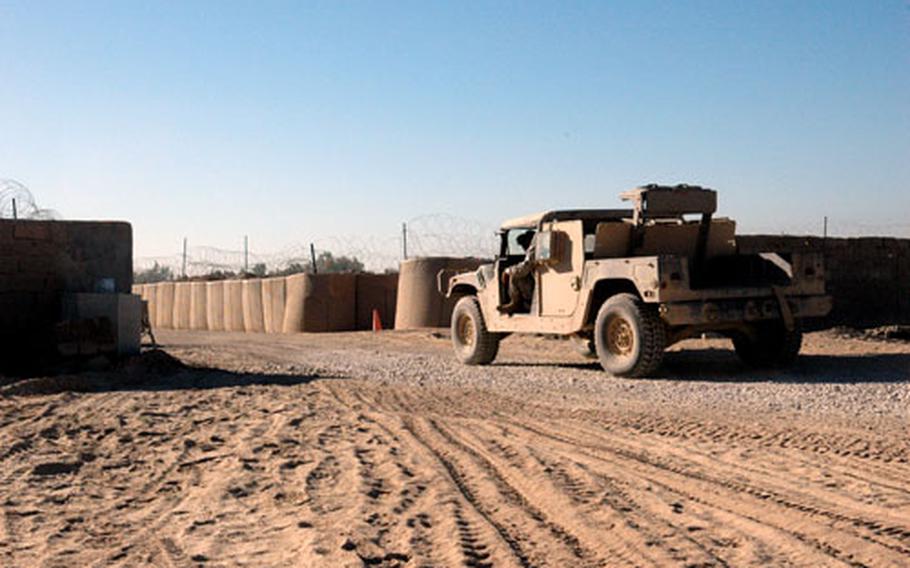 A truck rolls through the newly constructed gate that will serve as a main entry point for Camp Normandy.