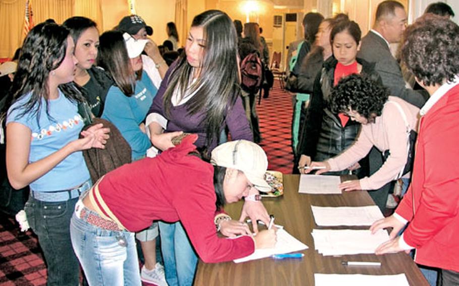 Employees from the club district outside Camp Humphreys in Pyeongtaek, South Korea, sign in at the Enterprise Hotel before a recent training session on curbing prostitution and human trafficking. The session was hosted by the Army’s Area III Support Activity at Camp Humphreys and Pyeongtaek City officials. Club owners and workers were invited.