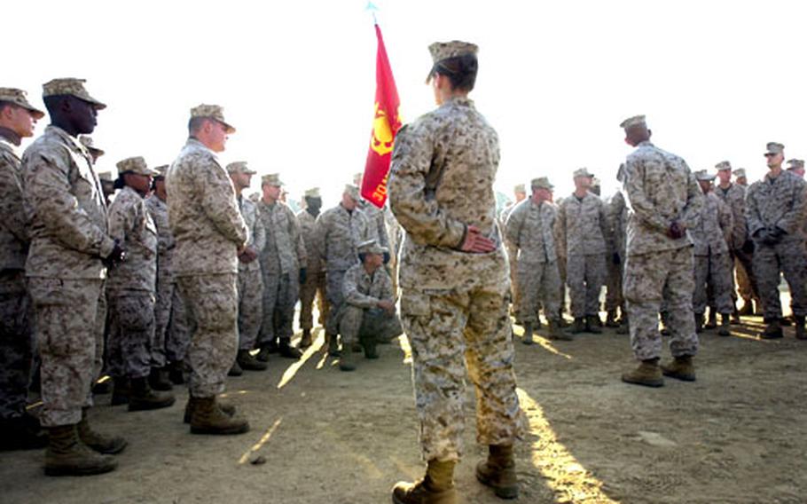 Marines and sailors from III Marine Expeditionary Force from Okinawa gather for the word of the day after a morning formation Tuesday in Shinkiari, Pakistan.