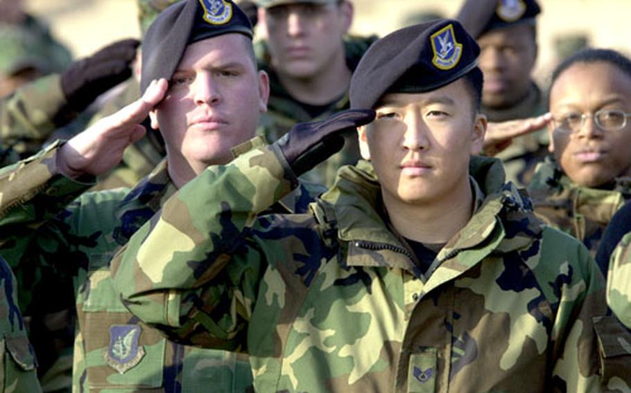 Airmen salute during the National Anthem prior to the president’s arrival.