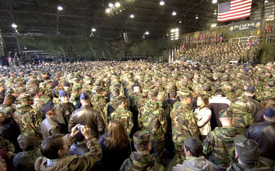 Members of all the services crowd into a hangar Saturday while awaiting the president’s arrival.