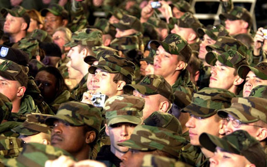 Troops strain to catch a glimpse of Air Force One as it lands at Osan.