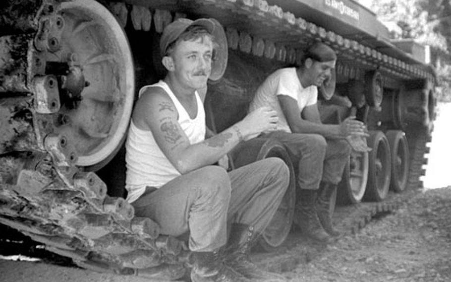 Break time during cleaning day for tank crew members at Camp Casey, South Korea, in September, 1975.