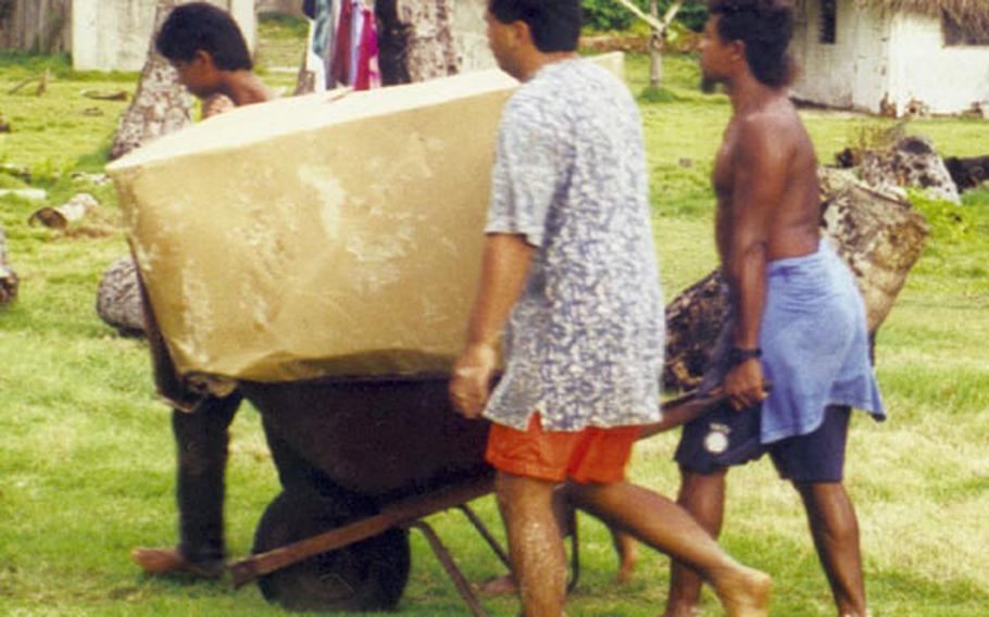 Residents of an outer island of Palau retrieve boxes