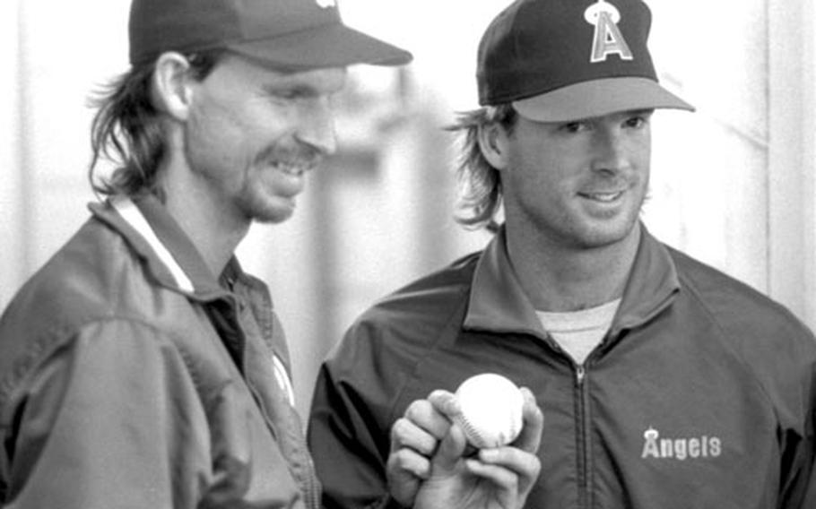 Randy Johnson and Chuck Finley pose for photos after the no-hitter against the Japan All-Stars.