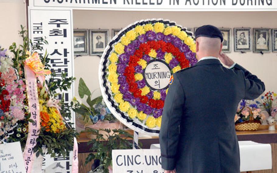 Lt. Col. Roger R. Dansereau, Pusan Storage Facility and Camp Hialeah installation commander, salutes during the 60th annual Namhae Memorial Ceremony on Monday to commemorate the loss of 11 U.S. Army Air Corps members killed during World War II.