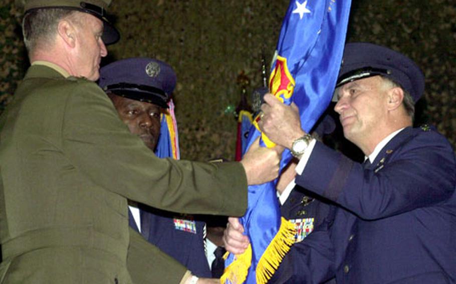 Air Force Gen. Tom Hobbins, right, accepts the command flag from Gen. James Jones, commander of U.S. European Command and supreme allied commander Europe, after taking over U.S. Air Forces in Europe during a ceremony at Ramstein Air Base, Germany, on Monday.