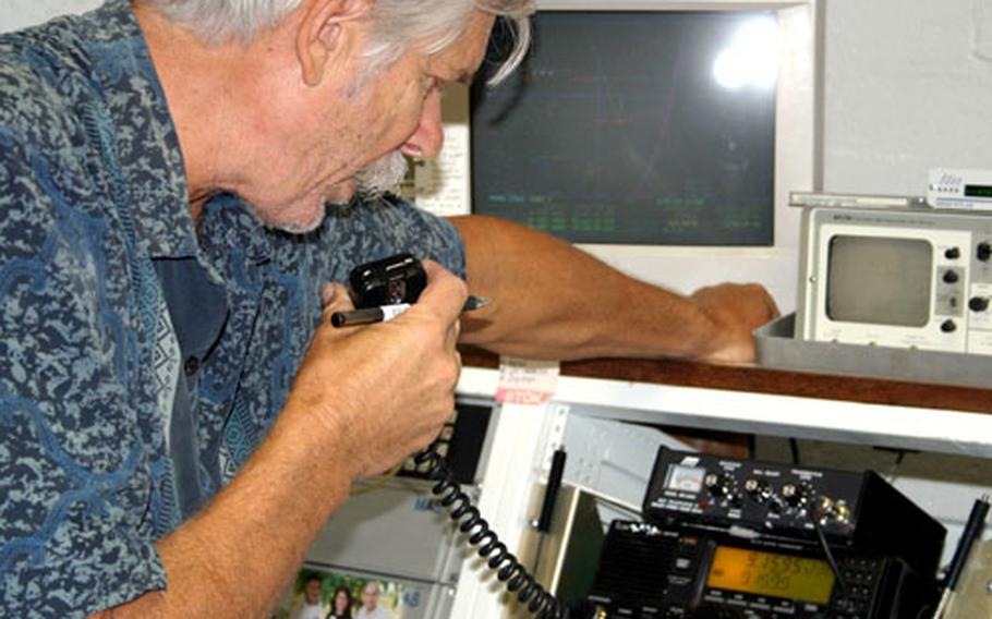 Bruce Best, manager of the PeaceSat communication station at the University of Guam, communicates with planes and islanders to coordinate the 2005 Christmas Drop.