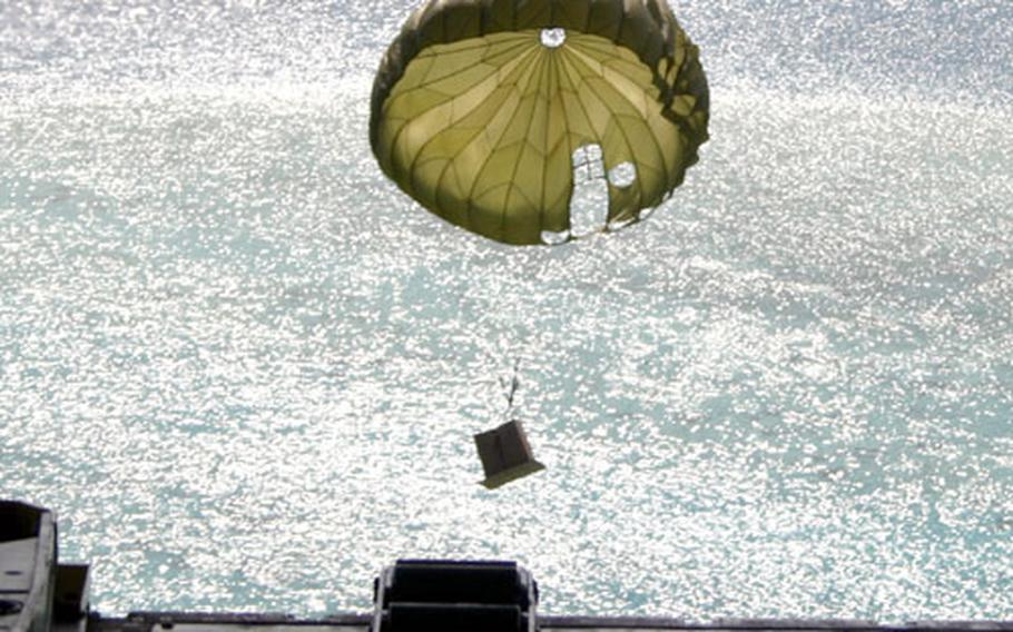 A box full of gifts and supplies makes its way to the water off Elato Island in Yap State in the Federated States of Micronesia. Boats were positioned below to retrieve the box.