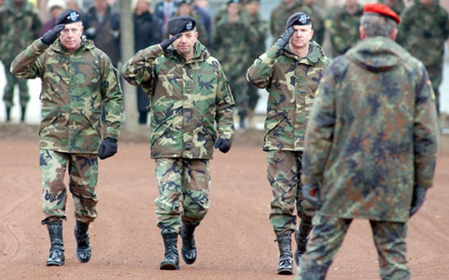 Gen. David D. McKiernan, Maj. Gen. David P. Valcourt and Gen. B.B. Bell salute the colors as they inspect U.S. Army Europe troops at the change of command ceremony in Heidelberg, Germany, on Wednesday. At right, German army Lt. Gen. Karl-Heinz Lather waits for McKiernan and Bell to inspect the Allied Land Component Command troops. McKiernan took over command of USAREUR and ALCC from Bell at the ceremony.