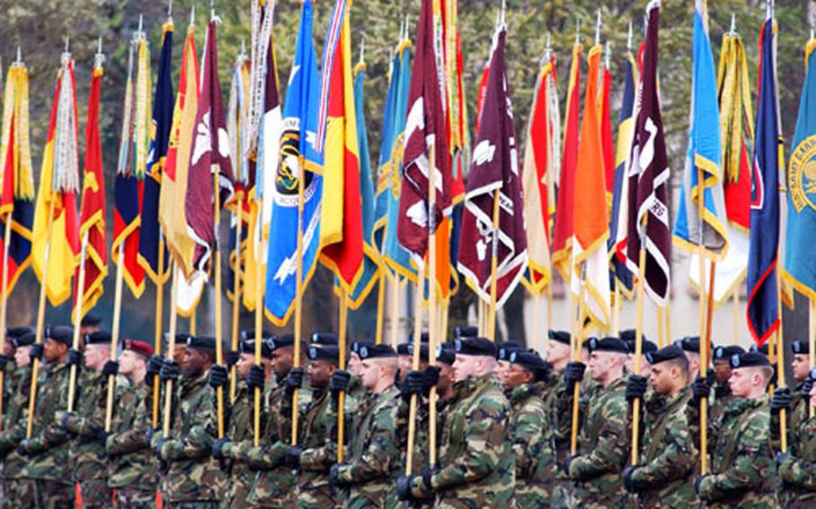 U.S. Army Europe troops hold unit flags at the USAREUR and Allied Land Component Command change of command ceremony.