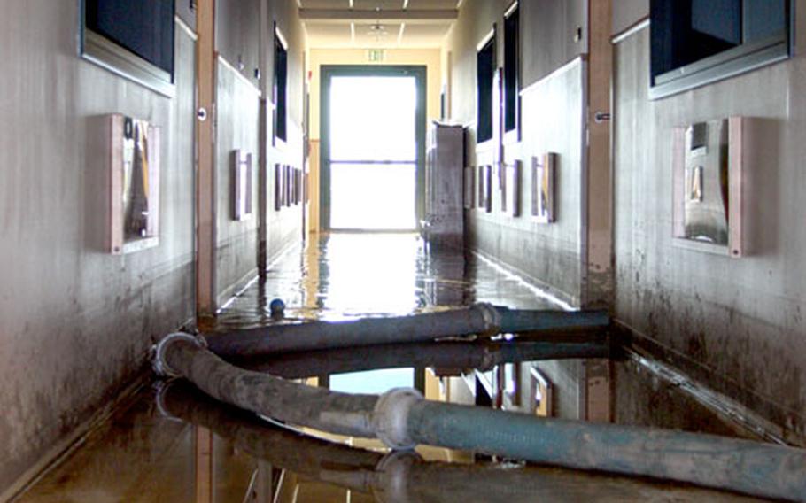 Standing water still floods a hallway of the Child Development Center on Monday, after a devestating flood last week ravaged the Maranai base housing area and the Naval Air Station 2 base at Sigonella, Sicily.