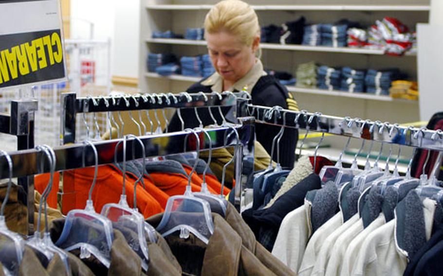 Lt. Cmdr. Lisa Braun from Sasebo Naval Base’s Navy Branch Health Clinic browses a clothing rack in the new Navy Exchange.