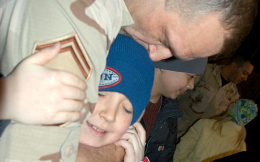 Senior Master Sgt. Tim Olearnick, of the 35th Logistics Readiness Squadron at Misawa Air Base, Japan, embraces his son, eight-year-old Maseo, after returning from a five-month deployment in northern Iraq. Olearnick said the best part about being home was “my family, and it’s my last one (deployment).”