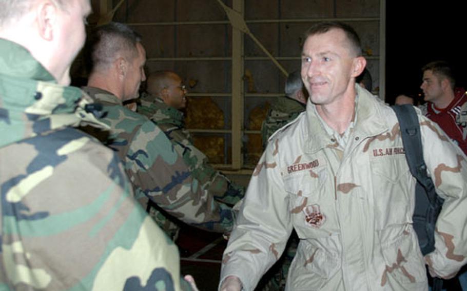 Lt. Col. Craig Greenwood, 35th Logistics Readiness Squadron commander at Misawa Air Base, greets senior military leaders after returning from deployment to Balad Air Base, Iraq, where he was the expeditionary logistics readiness squadron commander.