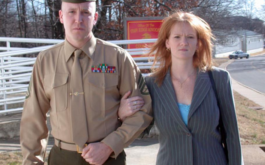 Marine Staff Sgt. Christopher VanGoethem leaves the Quantico Marine Base, Va. courthouse with his wife, Kathy, during a break in his trial Thursday.