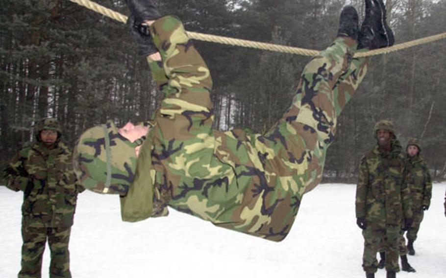 A 191st Ordinance Battalion soldier crawls along a rope at the Noncommissioned Officer Academy obstacle course in Grafenwöhr, Germany, on Thursday.