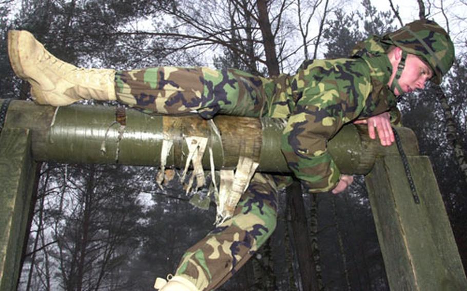 A 191st Ordinance Battalion soldier negotiates the "belly roll" obstacle.