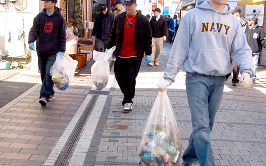 Volunteers from the USS Kitty Hawk have pledged to pick up trash twice monthly in the area around Yokosuka Naval Base.