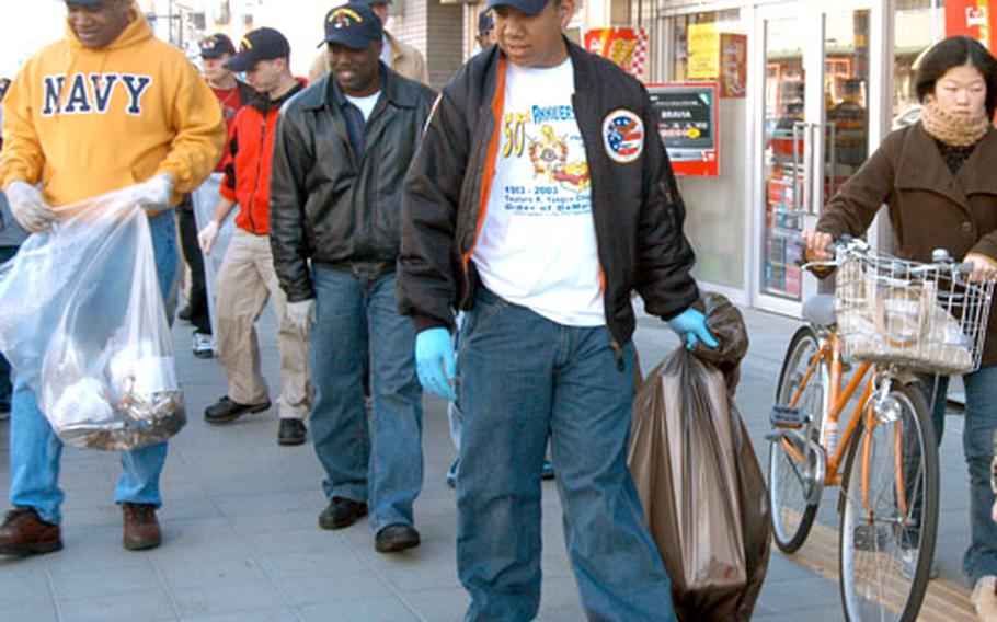 U.S. Navy personnel from the USS Kitty Hawk hit the streets in Yokosuka’s Honch nightlife district on Friday morning to perform the first of severval clean-ups planned for the area.