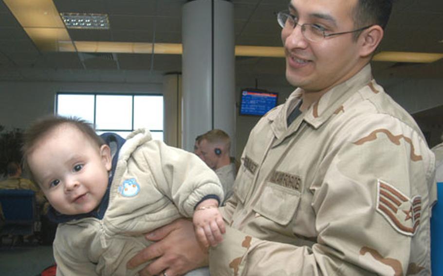 Staff Sgt. Joel Fernandez plays with his 8-month-old son, Jeremy, as he waits for a flight out of the RAF Mildenhall passenger terminal on Thursday. Fernandez, an aircraft communication and navigation maintainer from Mildenhall&#39;s 352nd Maintenance Squadron, left to a four-month deployment to Iraq.