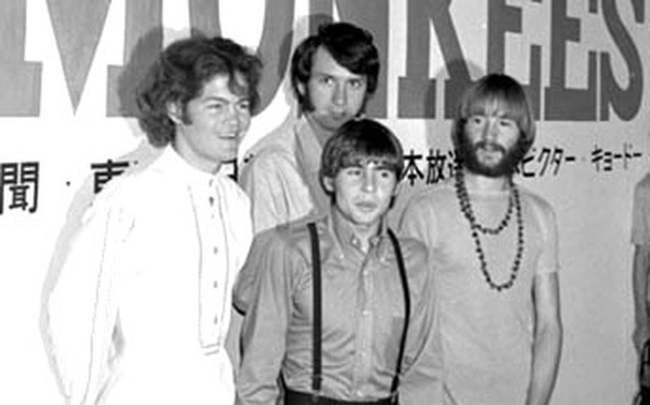 The Monkees pose for photographers.
