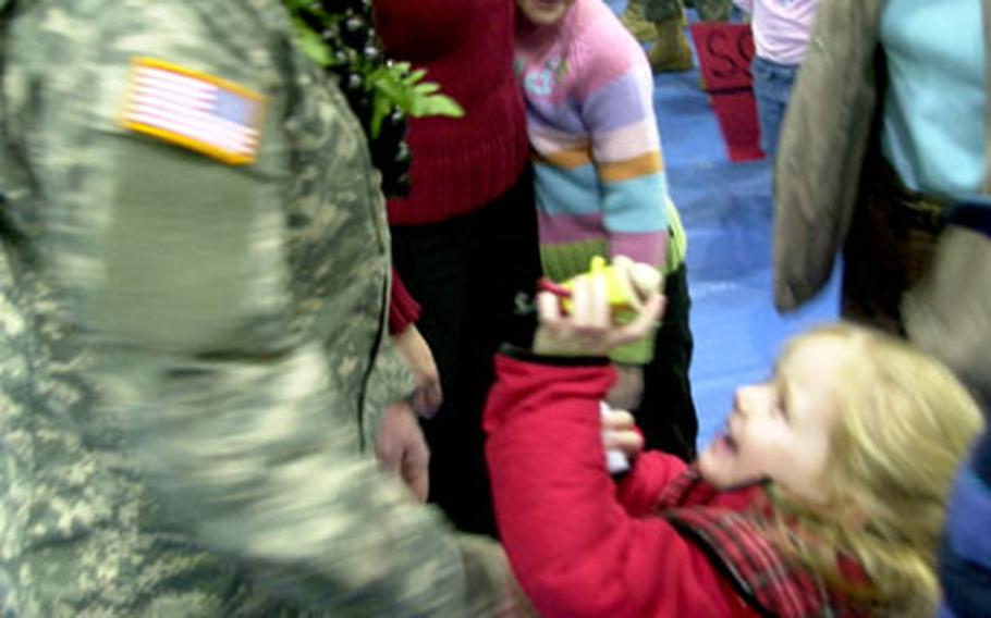 Lt. Col. Steven Vass, 41, of Wallingford, Conn., who leads one group of 44 Security Police Transition Team soldiers who will deploy to the Gulf this week, says goodbye to his family on Tuesday at Hohenfels, Germany.