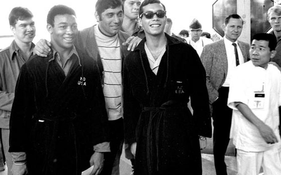 Joe Namath poses with a group of servicemembers at Camp Oji, Japan, in January, 1969.