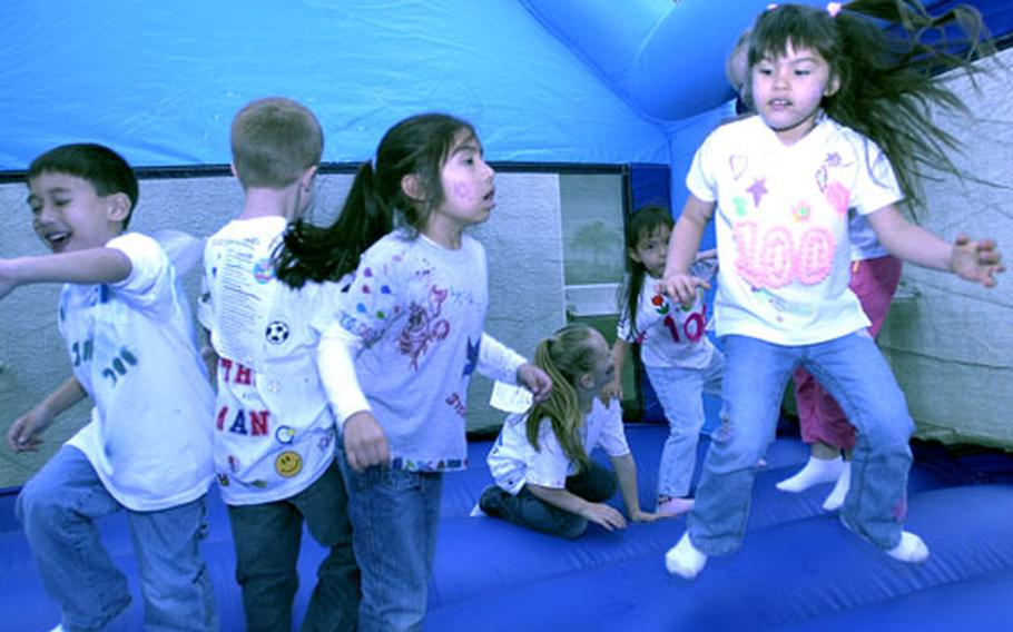 Students jump in a bouncer and counted to 100 by fives — a favorite activity of many of the children.