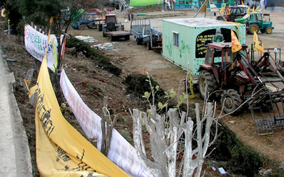 A view from a street just above the grounds of the Daechu-ri Elementary School shows vehicles and heavy equipment lined up in a barricade.