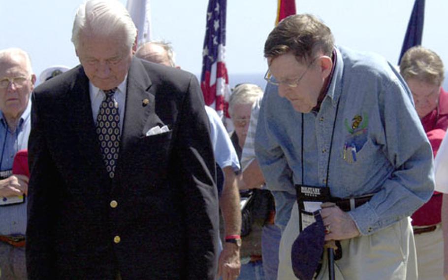 Retired U.S. Marine Corps generals Lt. Gen. Larry Snowden, left, and Maj. Gen. Fred Haynes pause for a moment of silence with other veterans of the battle of Iwo Jima during a 61st anniversary commemoration ceremony on Wednesday.