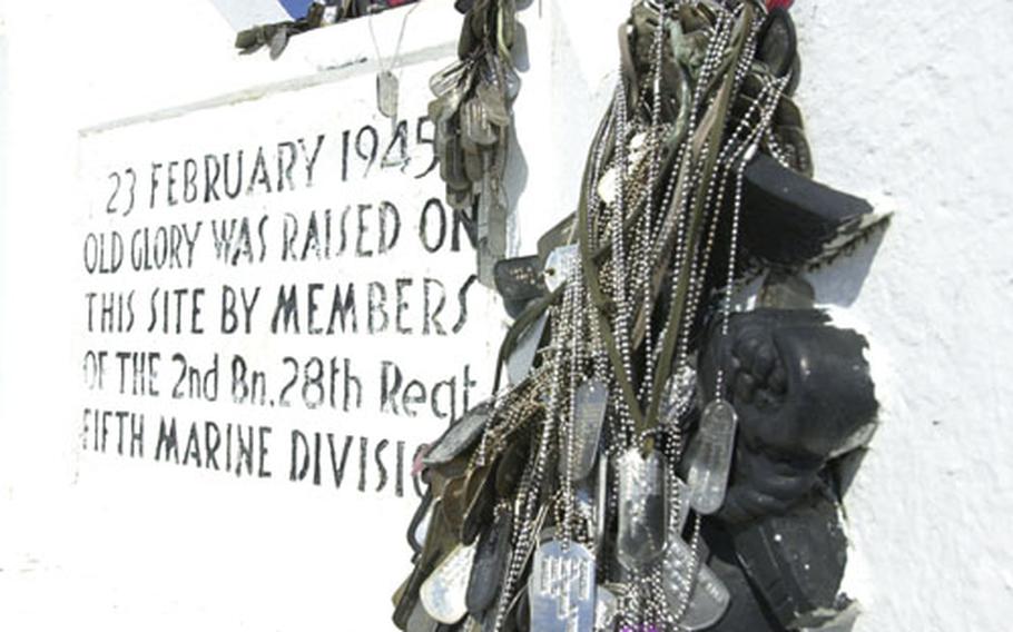 The monument paying tribute to the Mount Suribachi, Iwo Jima, flag raising in 1945 is adorned with dog tags of U.S. servicemembers who visited the site.