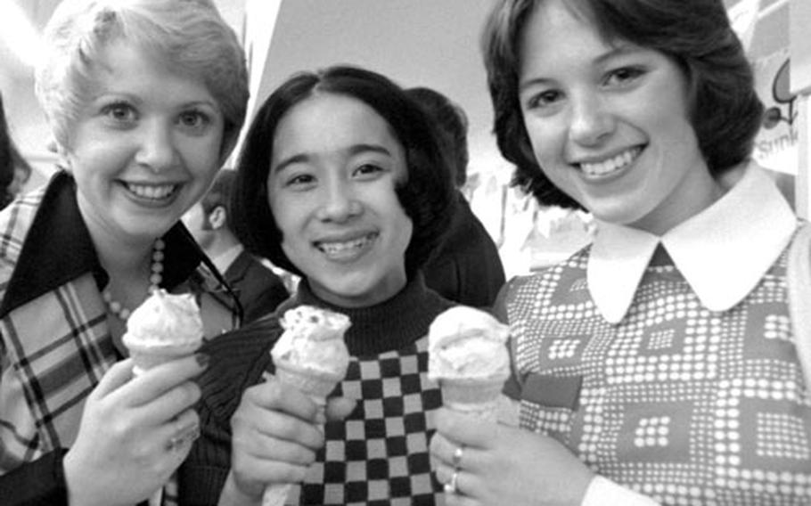 Standout figure skaters Karen Magnussen of Canada, Cathy Watanabe of Japan and Dorothy Hamill of the U.S., left to right, take an ice cream break.