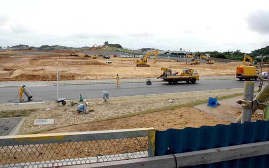 As workers finish straightening Montana Street, others prepare the ground for new multi-family homes in the Chatan East housing area behind the Camp Foster base exchange complex. The $79 million project includes 130 three-bedroom units and 30 two-bedroom units.