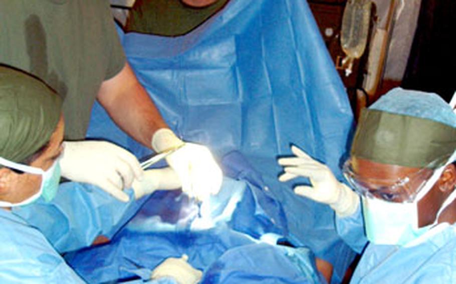 Medical personnel assigned to Combat Logistics Company 35 perform a mock surgery in the Forward Resuscitative Surgical Suite during a mass casualty scenario last week at Rodriguez Range, South Korea.