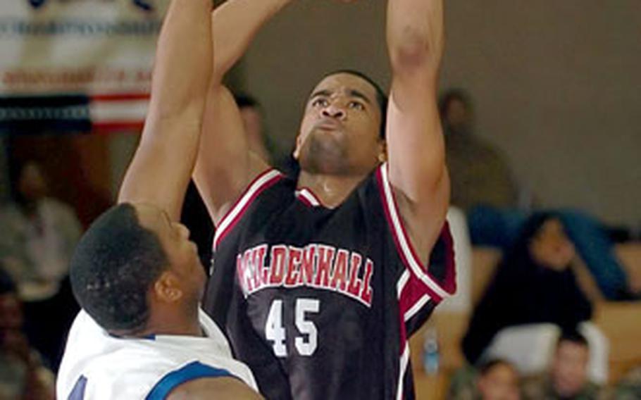 Mildenhall’s Dylan Goldwire sinks a basket over Ramstein’s Larry Senegal during the USAFE championship game last month.