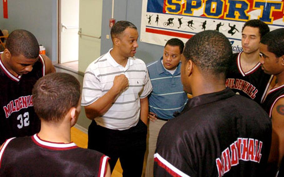 Mildenhall coaches and players discuss strategy Sunday during a timeout at the U.S. Forces Europe championship in Germany.