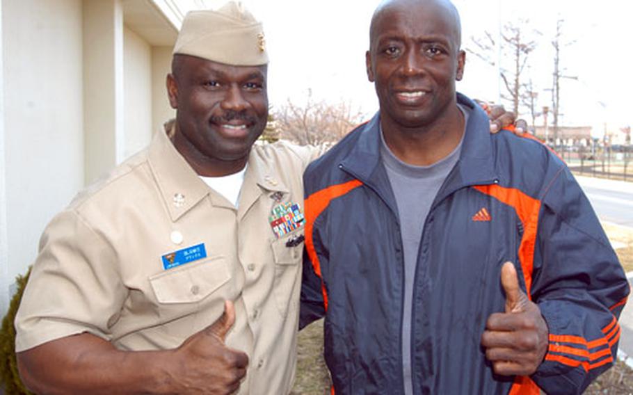 Navy Master Chief Charles Blanks, left, command master chief for Commander, Task Force 72 at Naval Air Facility Misawa, stands with his brother, Billy Blanks, outside the American Forces Network studio at Misawa Air Base, Japan. Billy Blanks, the creator of Tae-Bo, spent time with brother Tuesday, the first day of a five-day visit to five U.S. military bases in mainland Japan this week.