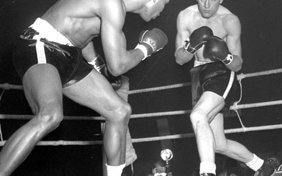Sugar Ray Robinson sizes up his opponent, Hans Stretz, during their fight in Frankfurt on Christmas night, 1950.