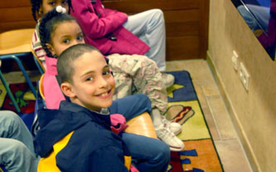 Children are temporarily diverted from watching a movie during Kids Night Out, a program under which they are supervised by staff members at the Edelweiss Lodge and Resort in Garmisch so their parents can have some time alone.