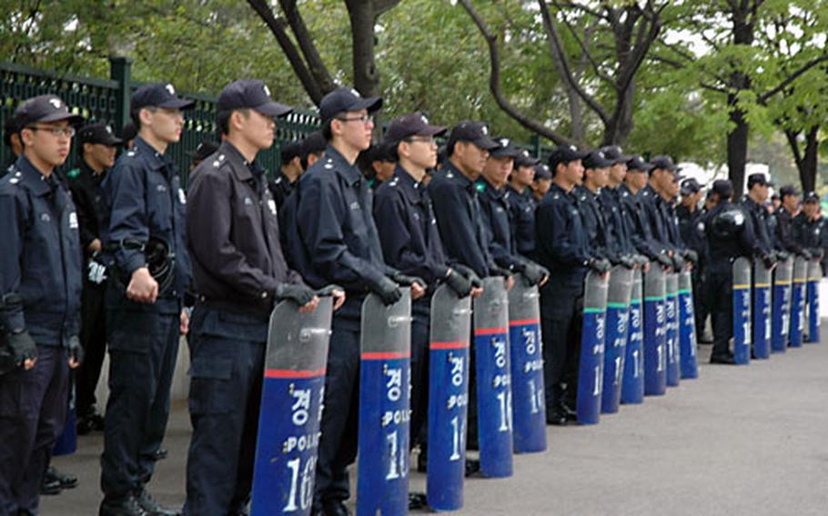 Hundreds of South Korean riot police stand by Saturday morning outside the South Korean Ministry of National Defense near Yongsan Garrison.