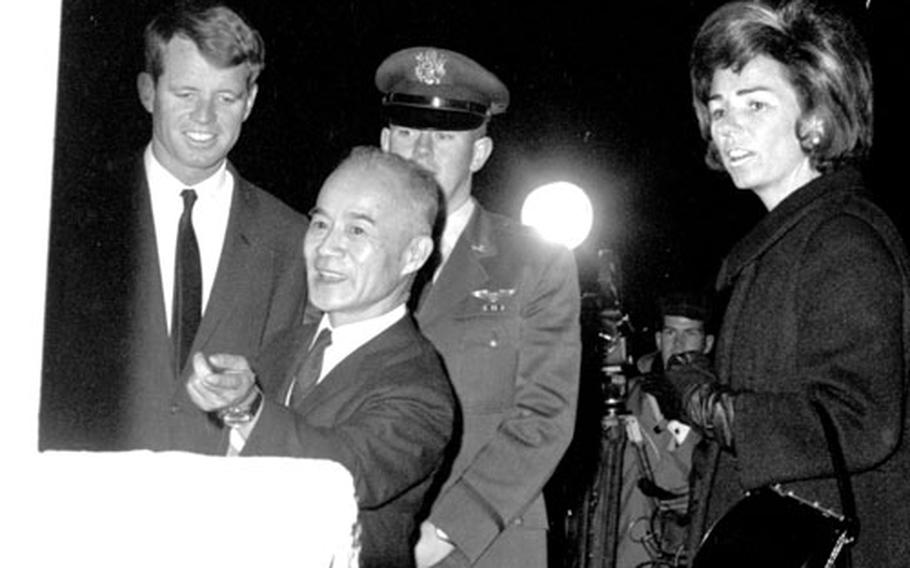 Robert Kennedy and his wife, Ethel, inspect the John F. Kennedy memorial at Yokota. With them is Ryosuko Harada, chairman of the Japanese monument committee.