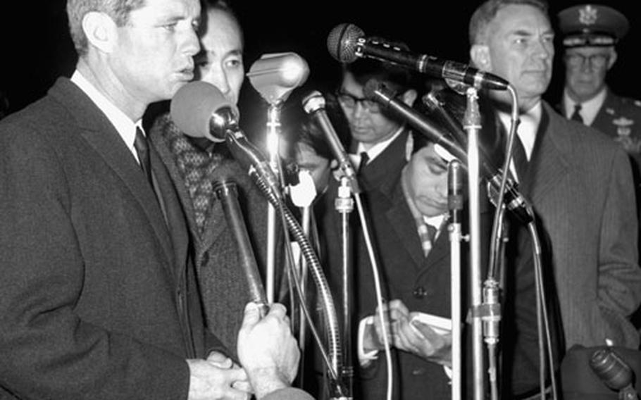 Robert Kennedy speaks to reporters and well-wishers at Yokota. At right is the U.S. Ambassador to Japan, Edwin O. Reischauer.